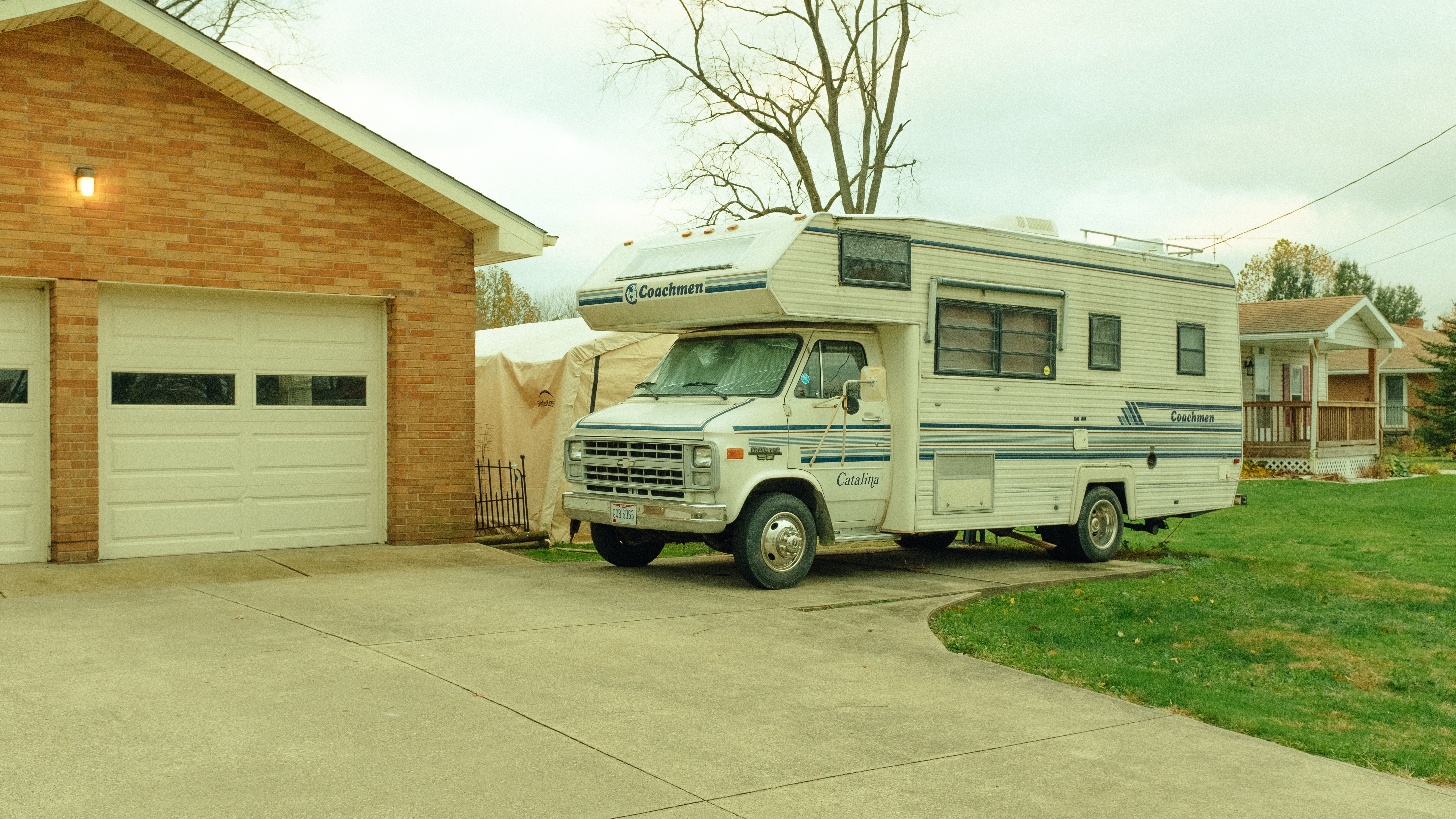 A used RV sits in a driveway in this guide to buying a used RV