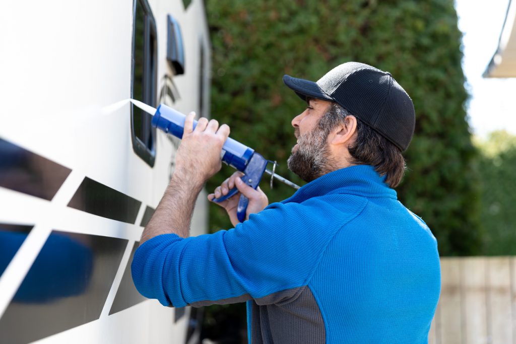 Sell My RV Myself: A man makes repairs to his RV before listing it for sale.