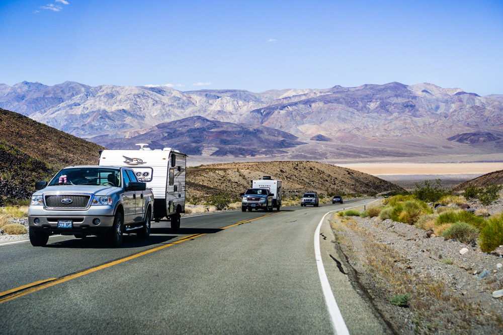 A truck tows a travel trailer through the desert. We detail the best truck for towing a 7000 lb travel trailer
