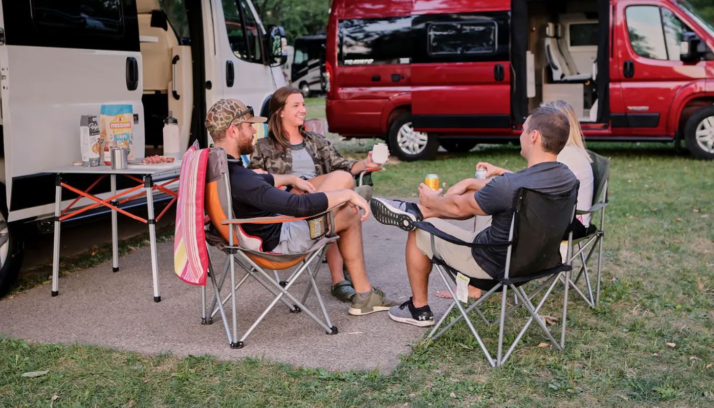 Best Class B RVs - people sitting in folding lawn chairs outside a Class B