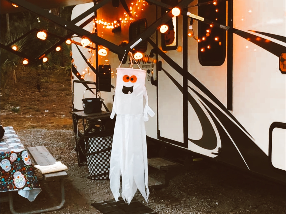 A ghost hangs outside as an RV Halloween decoration