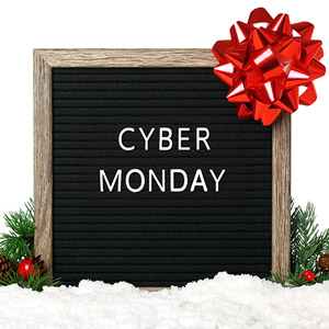 A sign decorated with a bow and holiday evergreens to represent Cyber Monday RV Deals