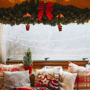 An RV window is decorated for Christmas. This list will help you find last minute RV gifts for your loved ones.