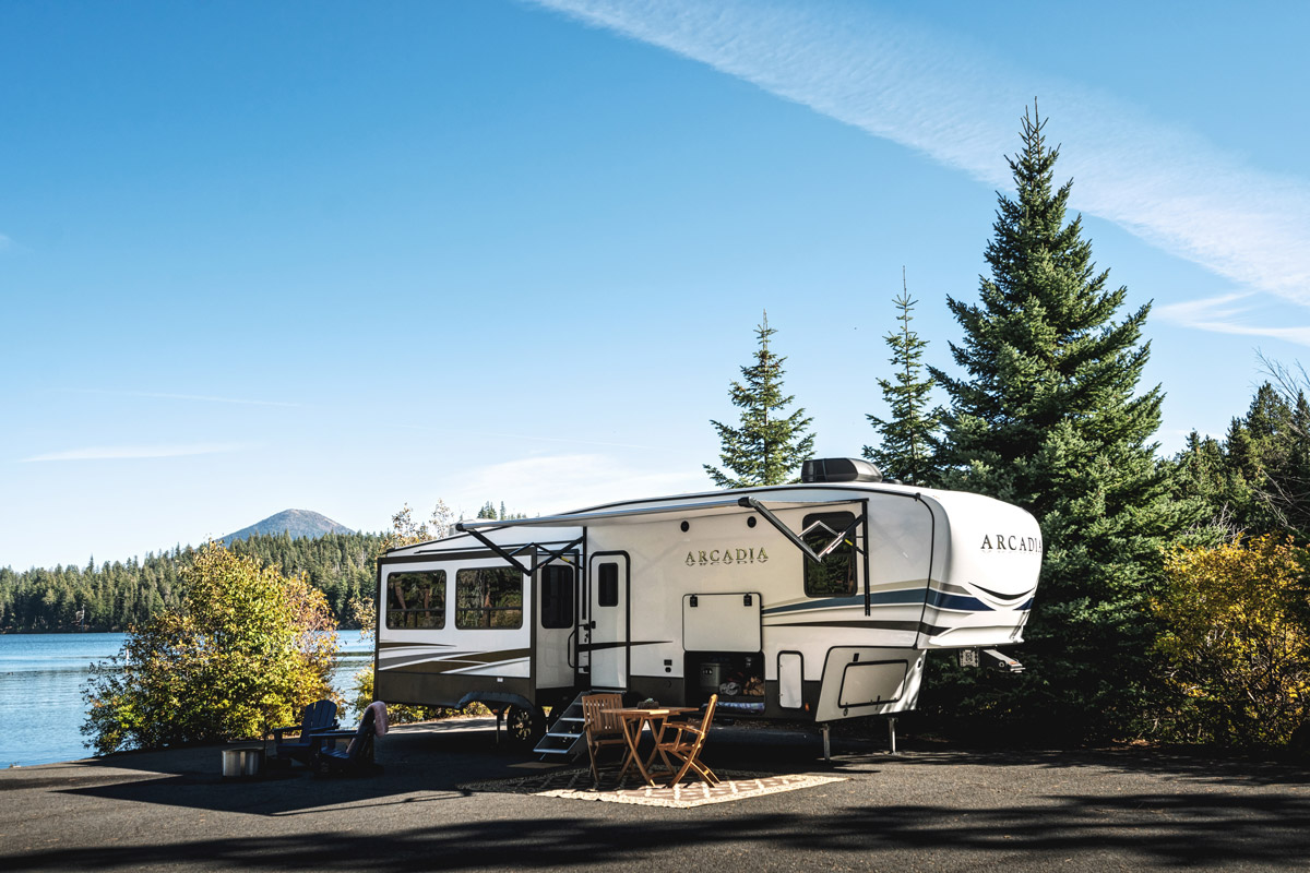 The Keystone Arcadia sits beside a lake. It's one of the hottest RVs for 2022