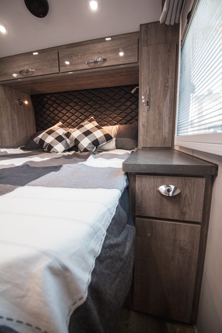 The bedroom of a Black Series HQ19, one of the overland trailers for sale on RVUSA