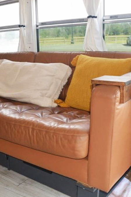 The couch of a skoolie for sale on RVUSA