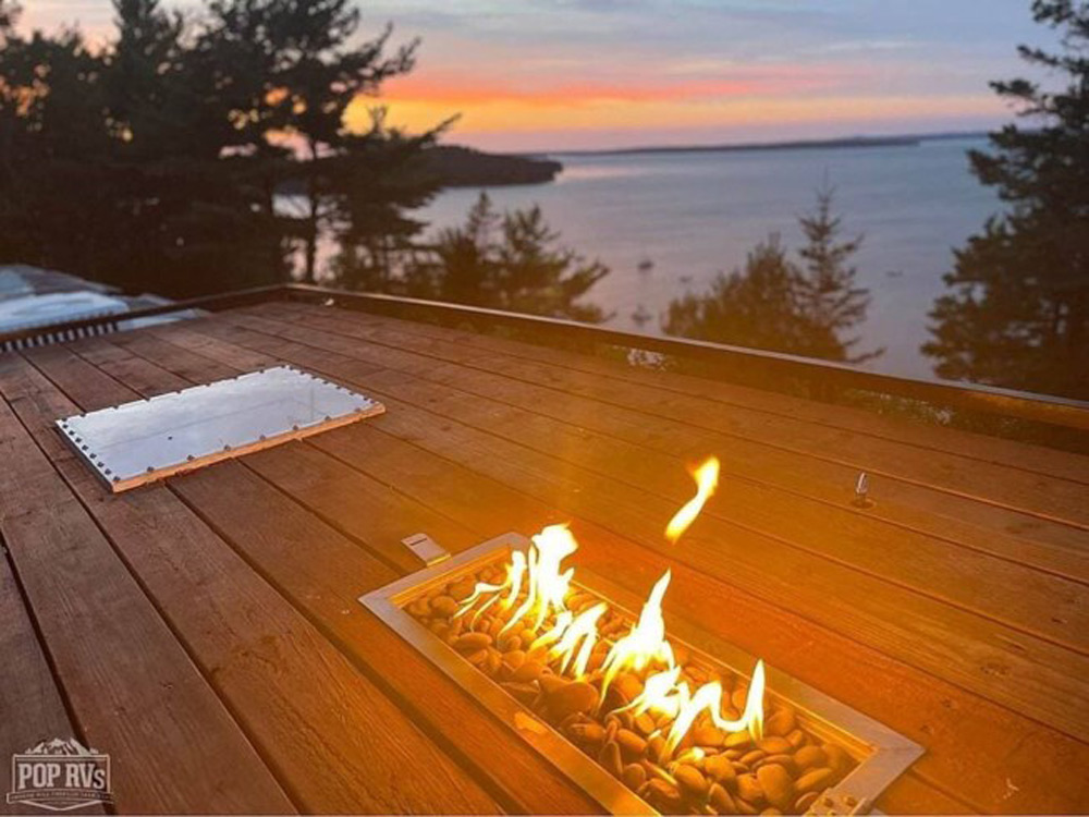 A rooftop fireplace on a renovated school bus for sale on RVUSA