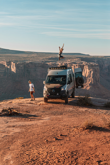A Storyteller Overland Beast MODE adventure van is parked on the rim of a canyon