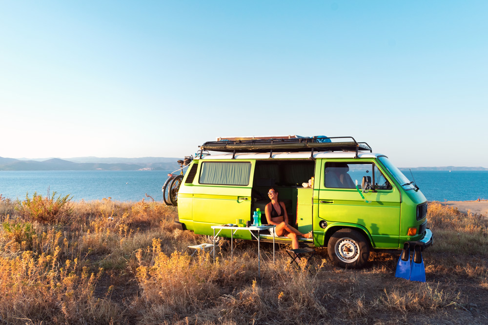 A camper van by the beach. Van life is a popular way to camp.