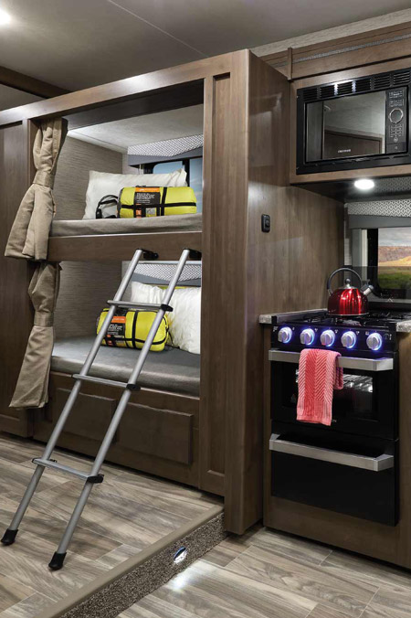 One of the top 10 most viewed RVs on RVUSA is the Thor Motor Coach Four Winds. This photo shows the kitchen and bunk area