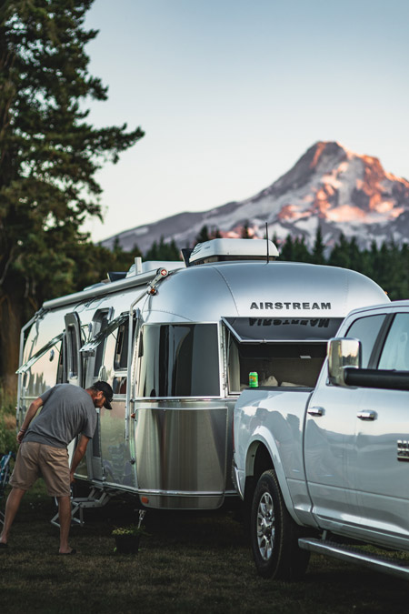 A man works on his airstream from his Harvest Hosts campground