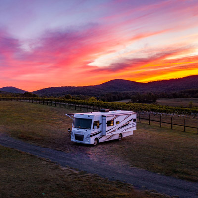 An RV camps at a Harvest Hosts site at sunset. This is the perfect gift for an RV dad