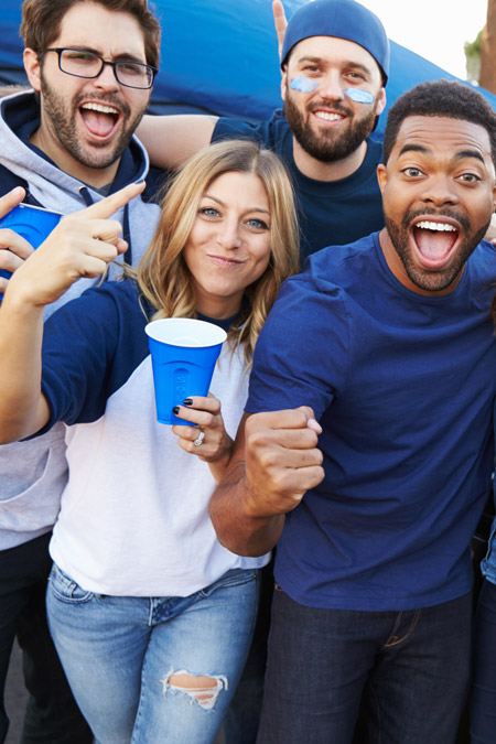 Fans pose at an RV football tailgate