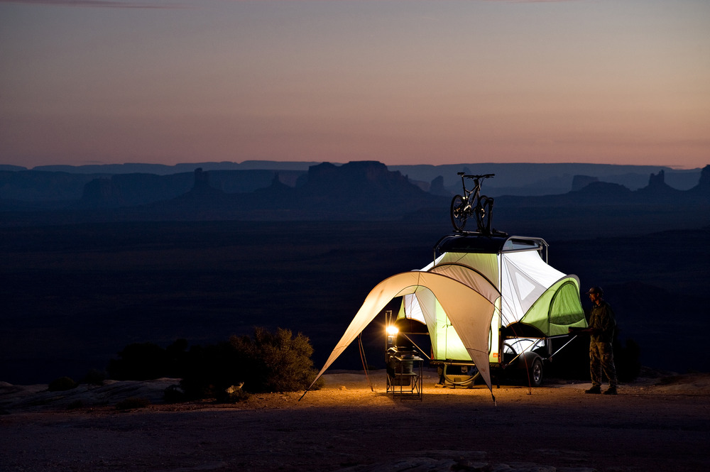 One of the coolest small campers on the market is the Sylvan Sport GO. This tiny camper is set up at night in the desert.